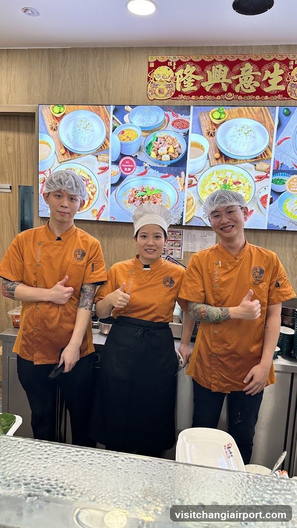 Chefs in Orange Uniforms Giving Thumbs Up