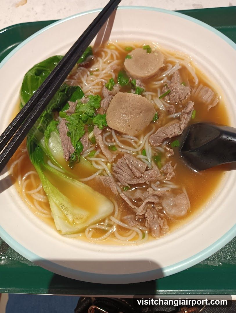 Bowl of Noodle Soup with Meatballs and Greens
