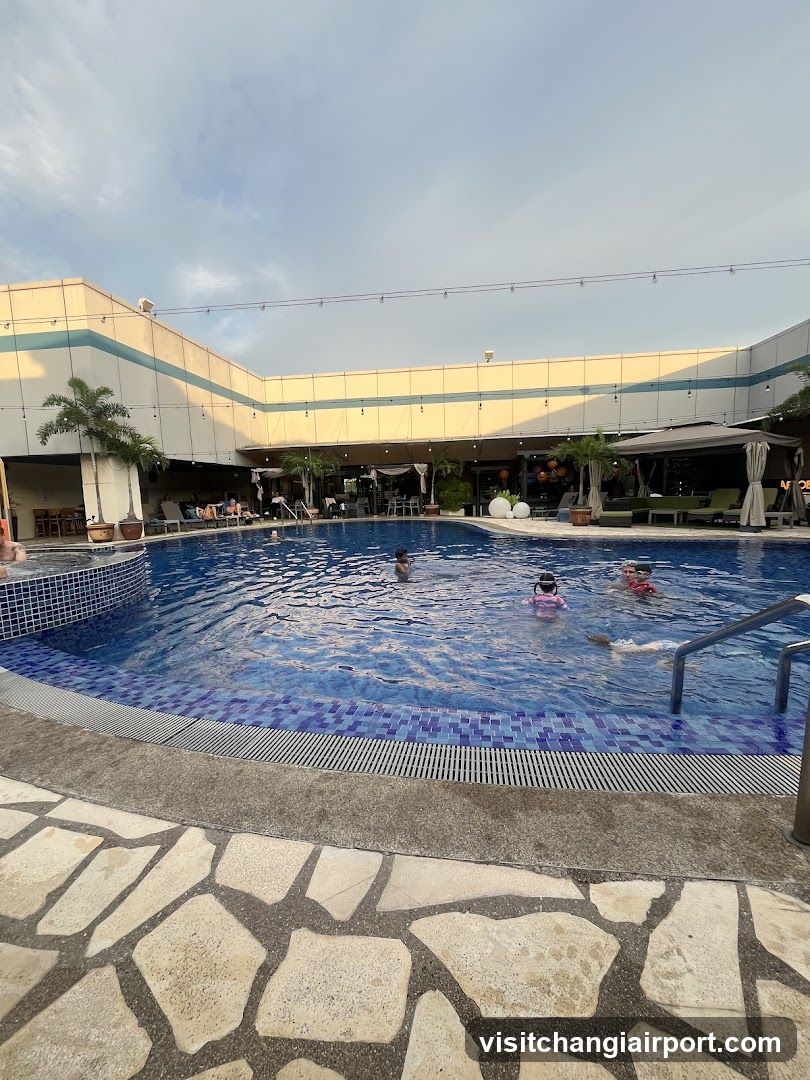Poolside Scene with Children Swimming