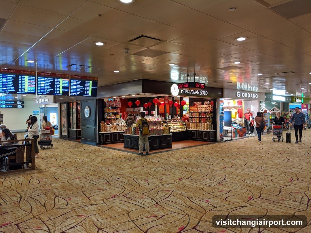 Airport Terminal Interior with Shops and Flight Information Board