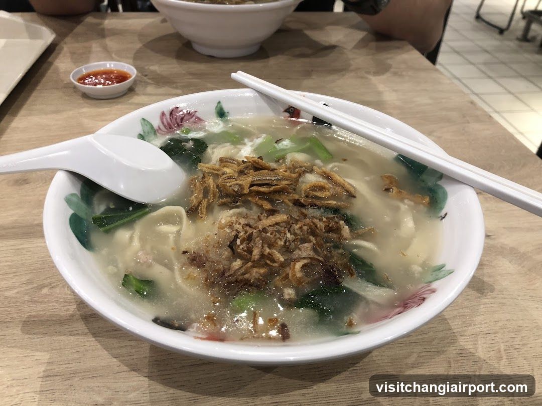 Bowl of Noodle Soup with Chopsticks and Spoon
