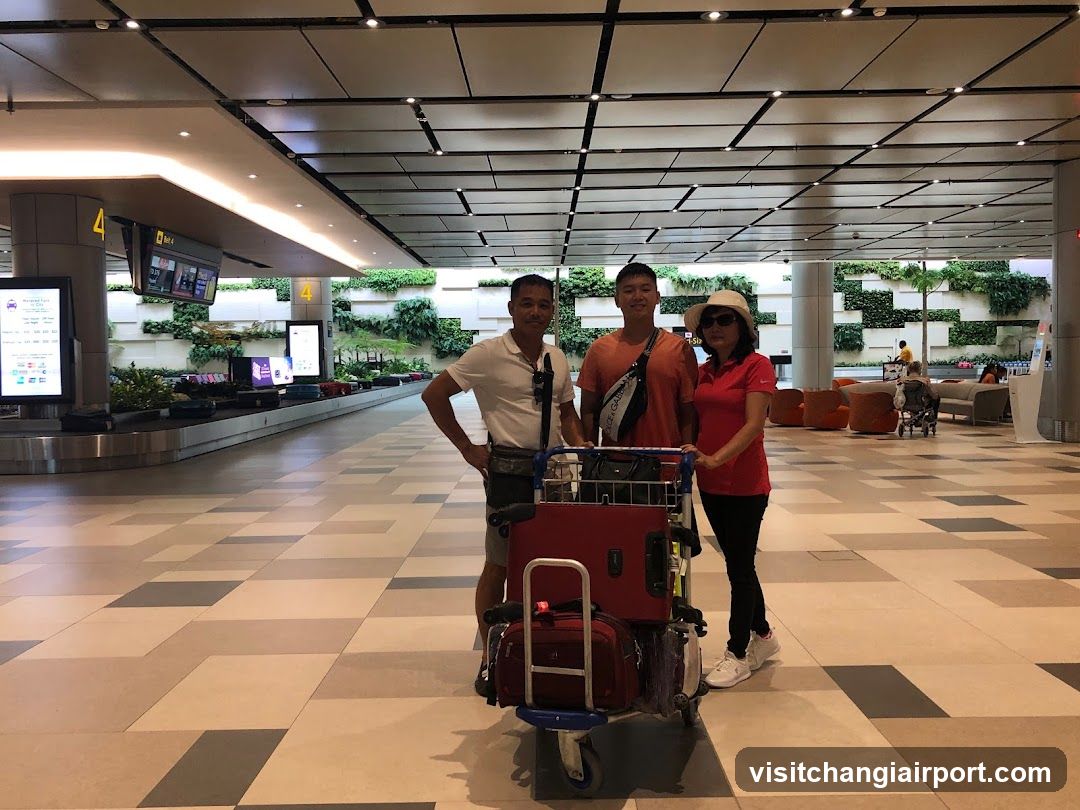 Airport Terminal Interior with Travelers and Luggage Cart