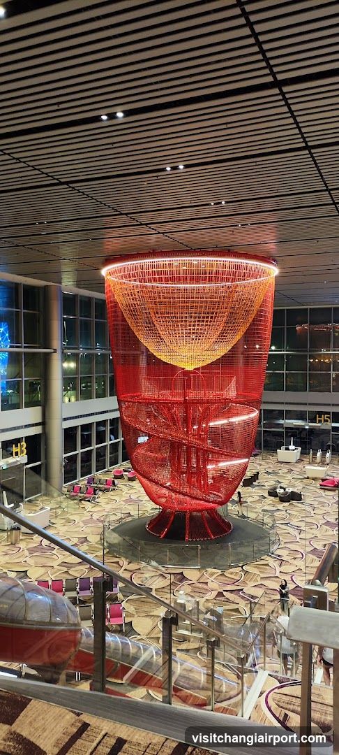 Red Spiral Sculpture in Airport Terminal