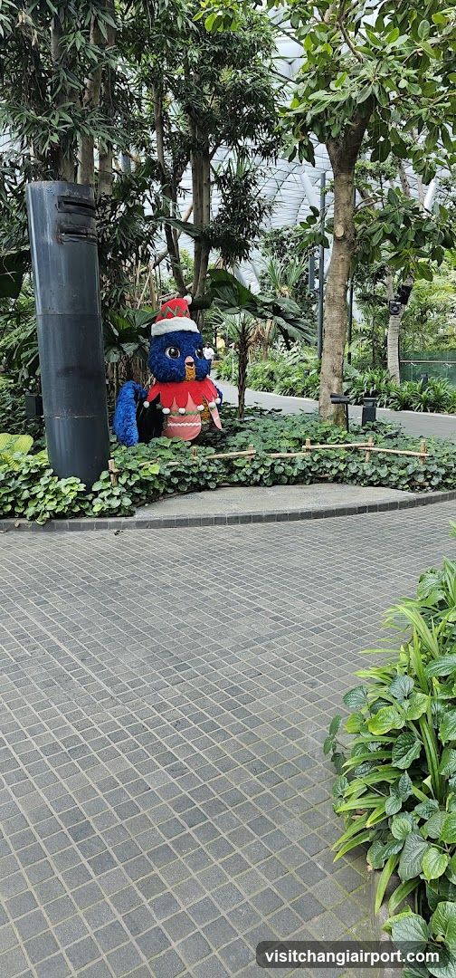 Christmas-themed bird statue in garden