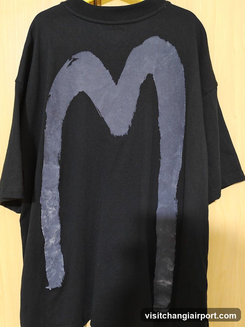 Black T-Shirt with Grey 'M' Graphic