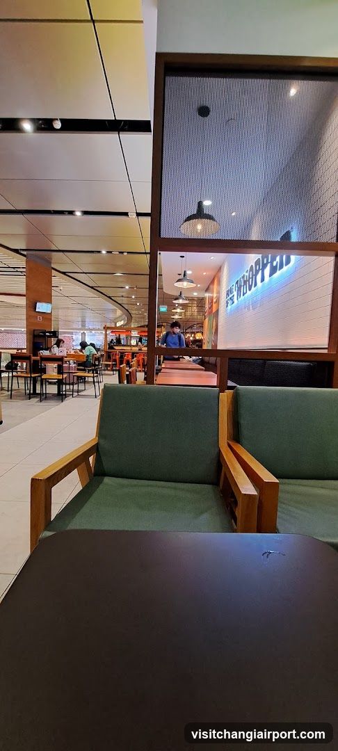 Interior seating area with food court background