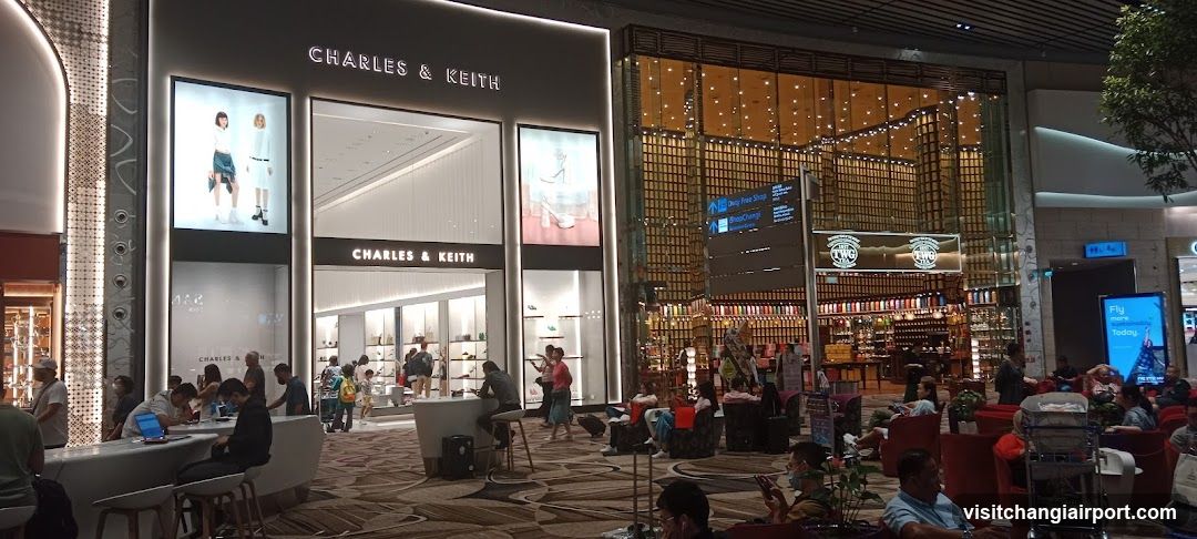 Shopping Mall Interior with Storefronts and Seating Area