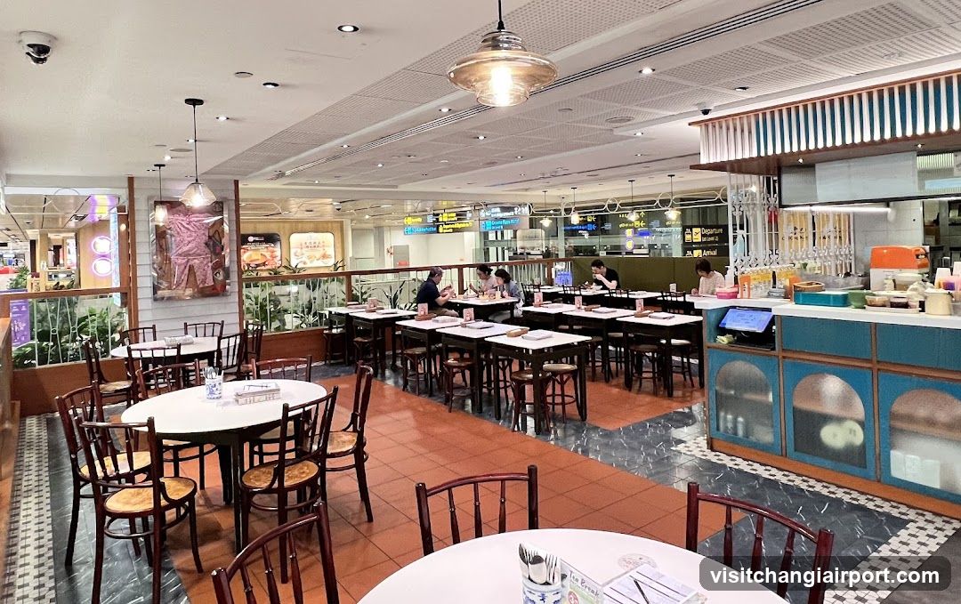 Restaurant Interior with Dining Tables and Kitchen Area