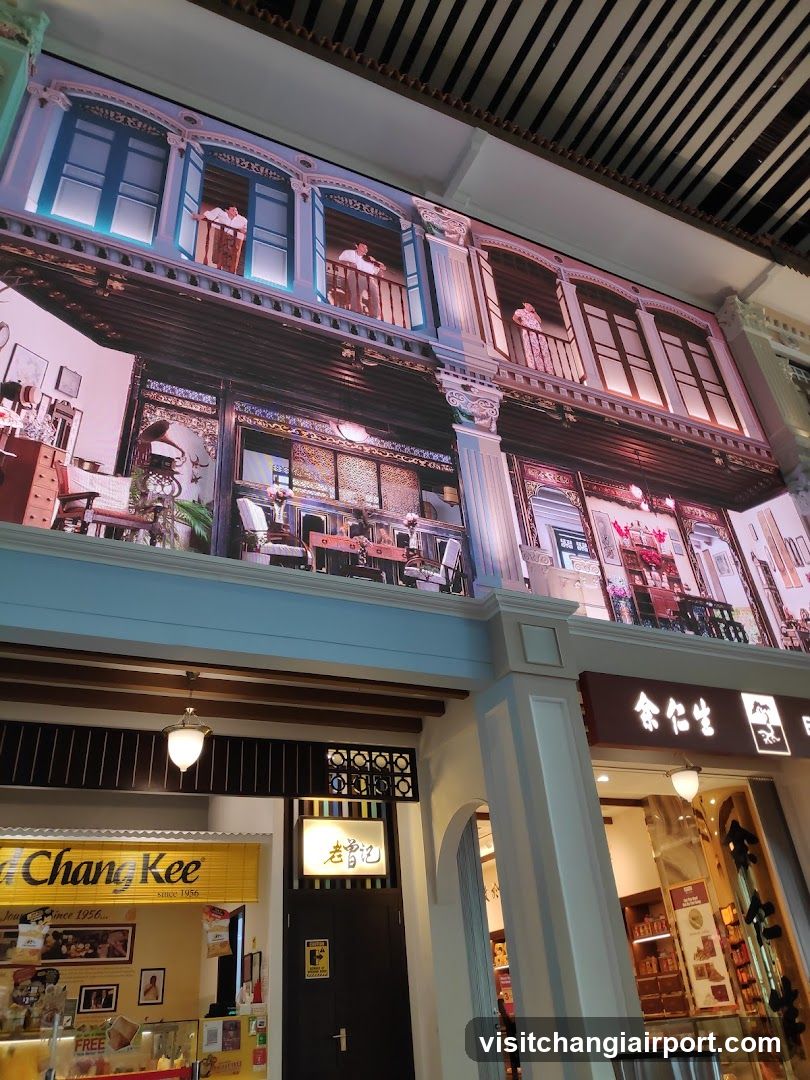 Interior view of a shopping mall with decorative facade mural