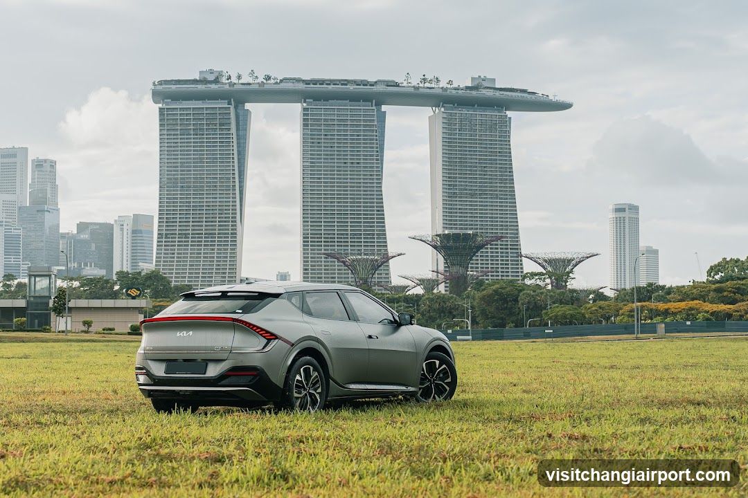 Car in grass with Marina Bay Sands background