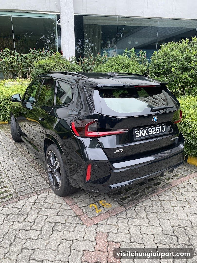 Black BMW X1 parked outside building