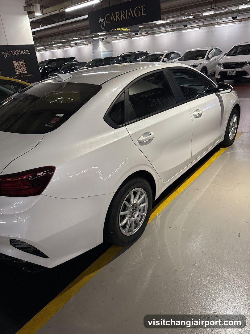 White sedan in parking garage