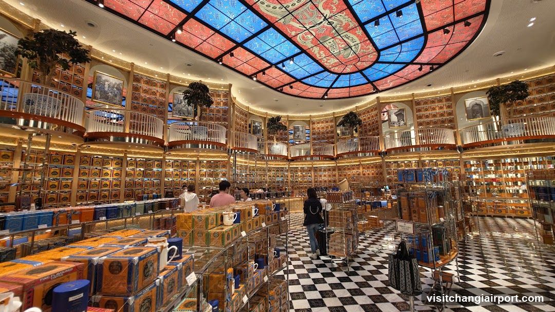 Interior of a large bookstore or gift shop with stained-glass ceiling