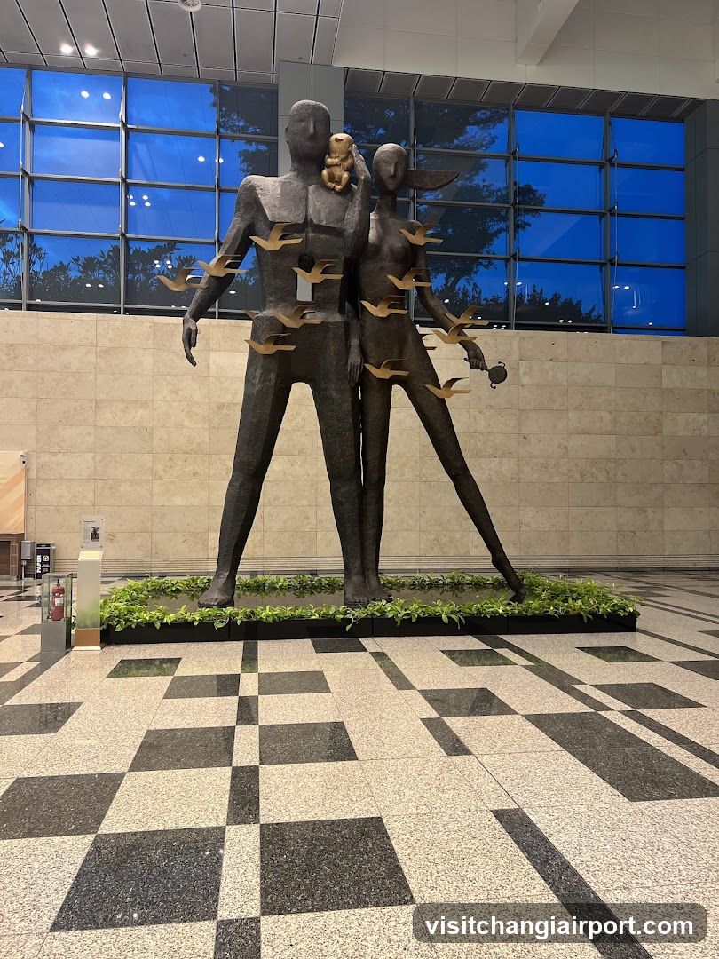Statue of Two Figures with Birds