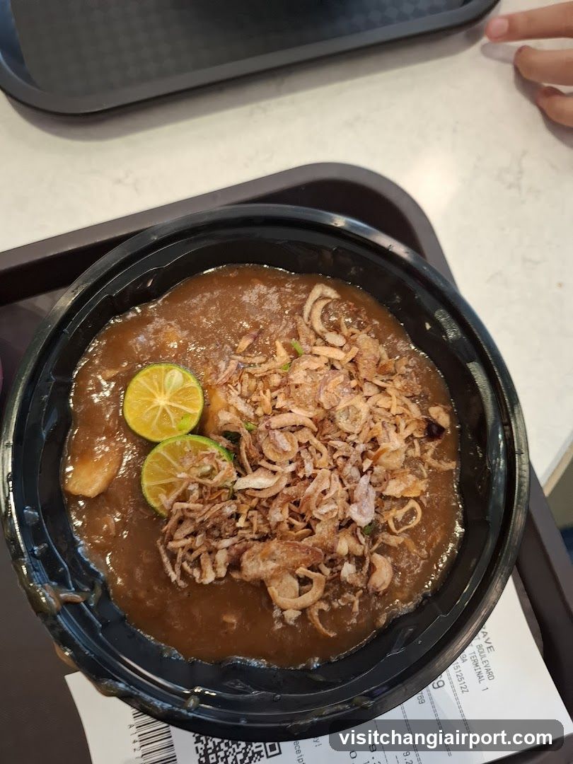 Bowl of Curry with Fried Onions and Lime