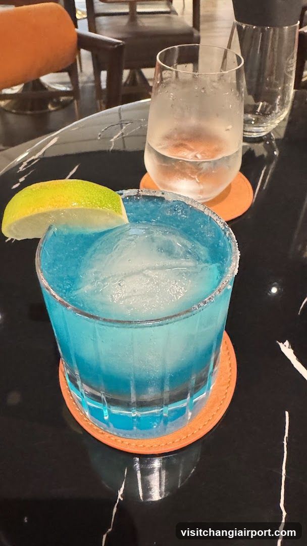 Blue Cocktail with Lime Garnish