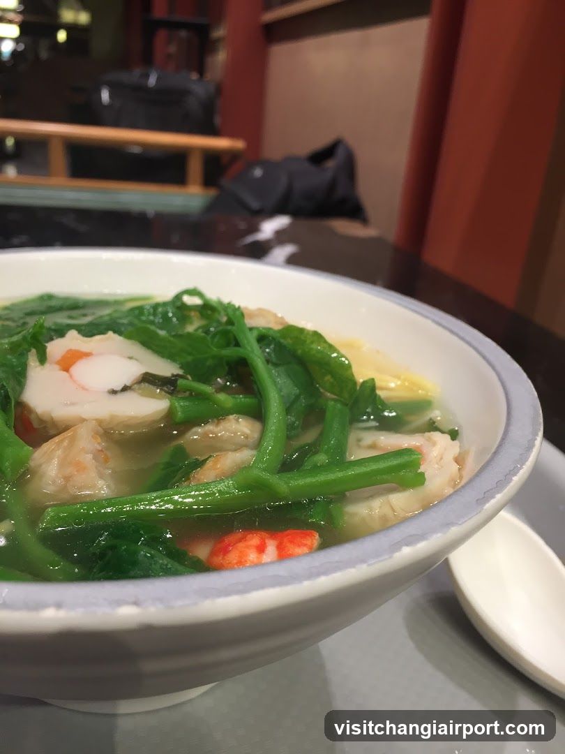 Bowl of Soup with Greens and Seafood