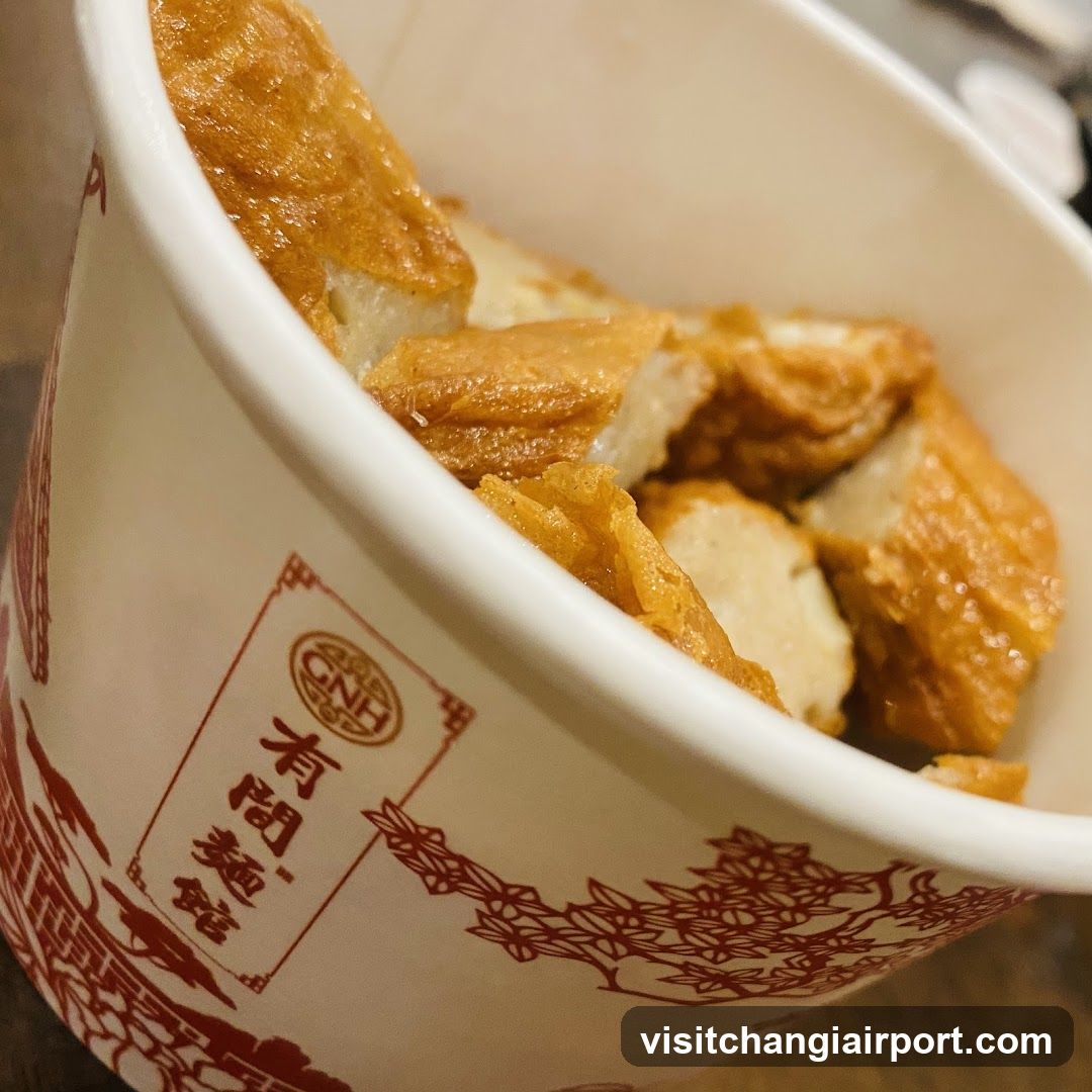 Bowl of fried dough sticks in branded cup