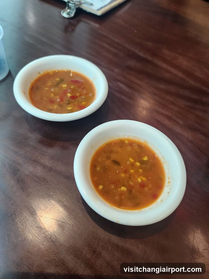 Two small bowls of soup on a wooden table