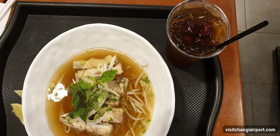 Bowl of Chicken Noodle Soup with Iced Drink