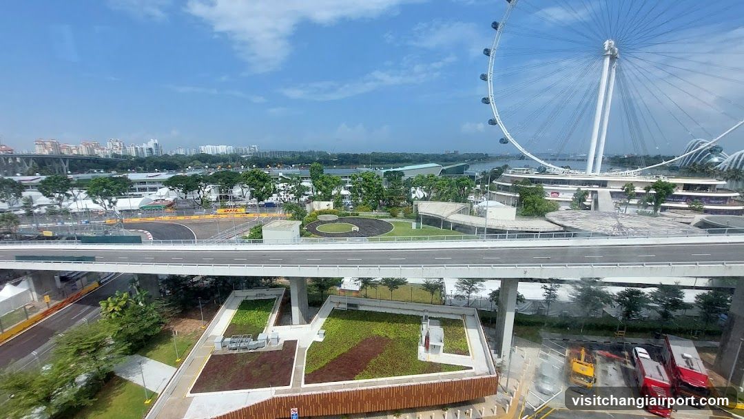 Elevated view of Singapore waterfront with Ferris wheel and elevated walkway