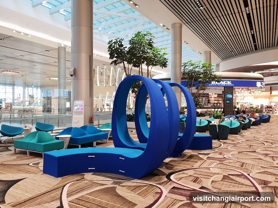 Airport Lounge Interior with Blue Seating and Art Installation