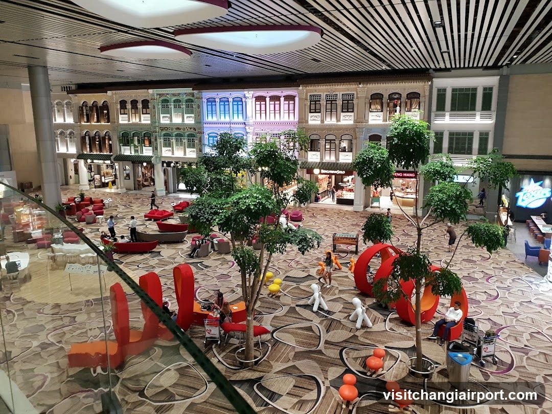 Shopping Mall Interior with Decorative Trees and Seating Areas