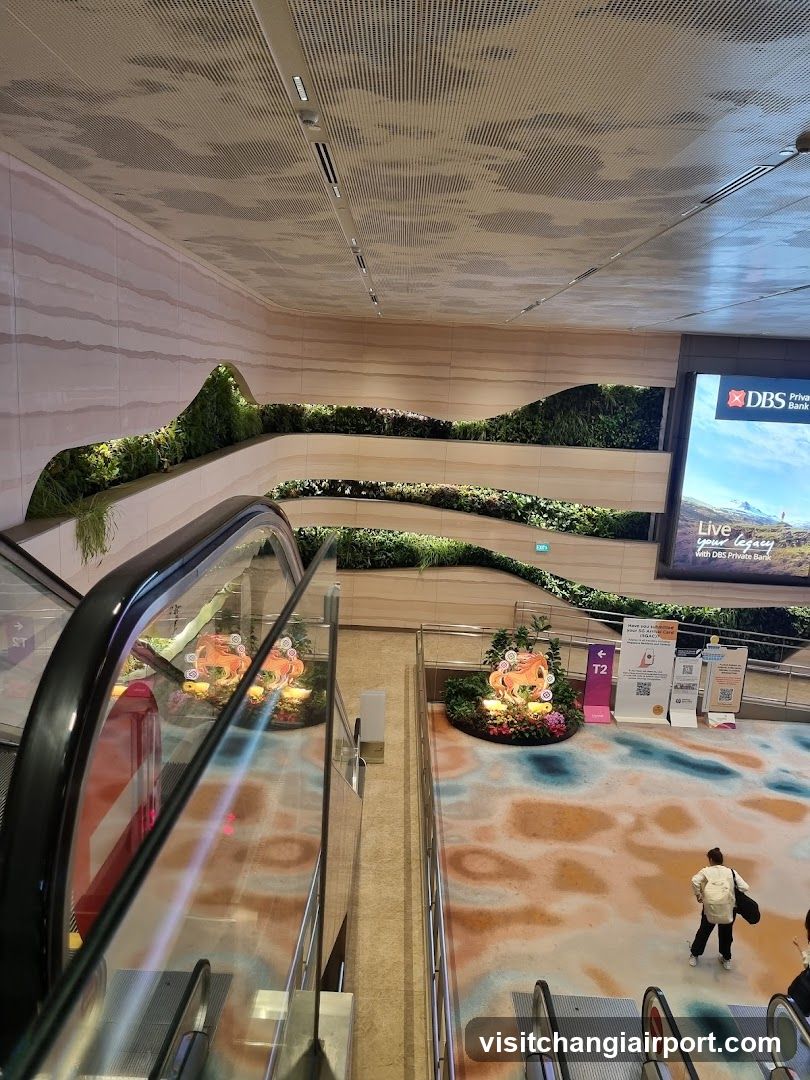 Indoor Shopping Area with Escalator and Green Wall