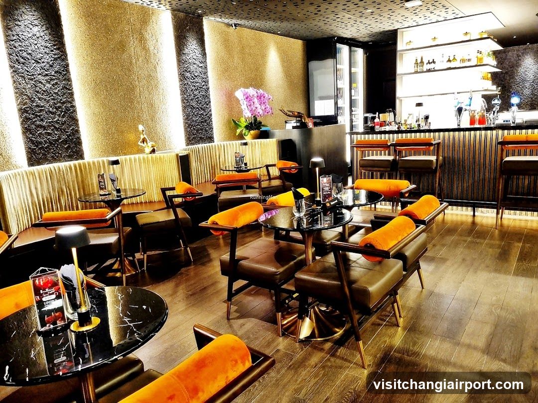 Bar Interior with Orange Upholstered Chairs and Black Tables