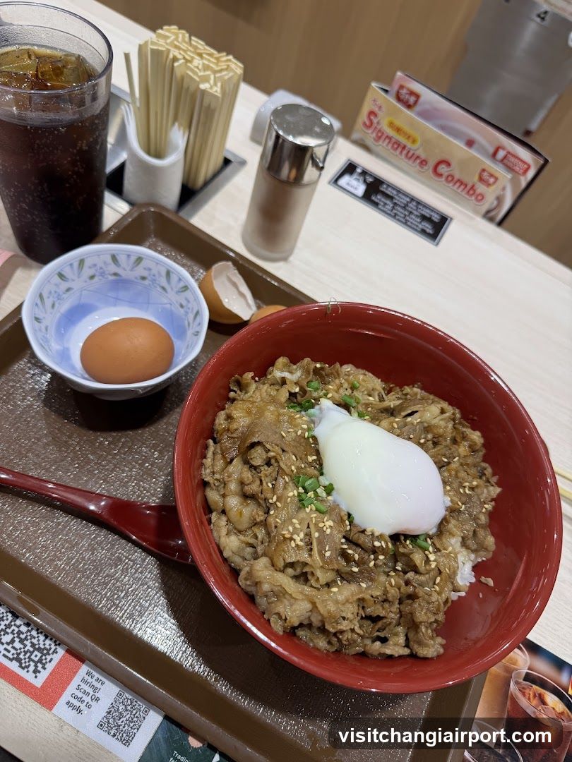 Bowl of beef rice with egg and drink