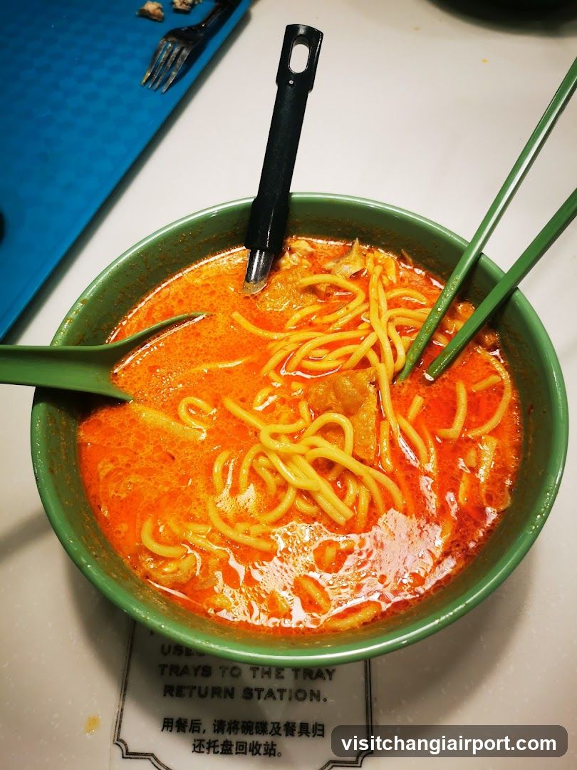 Bowl of Spicy Noodles with Chopsticks and Spoon