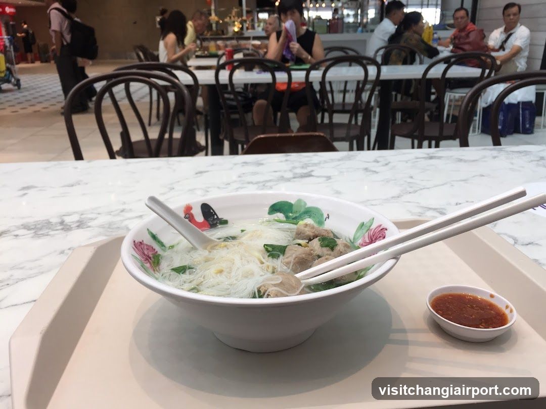 Noodle Bowl with Chopsticks and Chili Sauce
