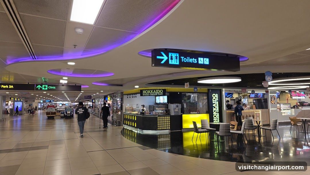 Airport Terminal Interior with Food and Restroom Signage