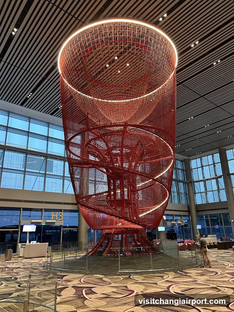 Red Spiral Sculpture in Airport Terminal