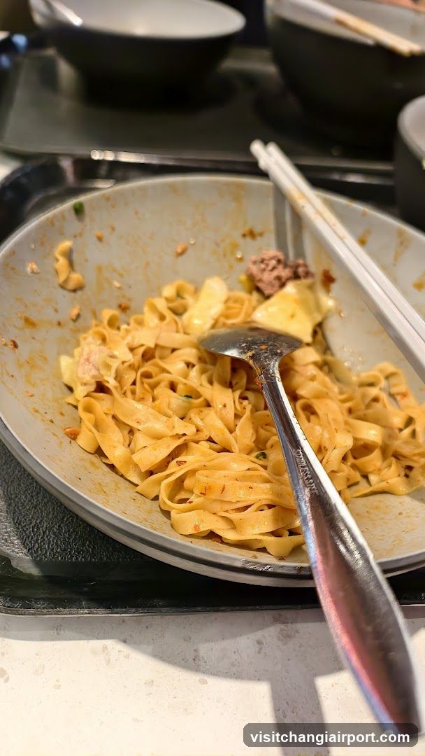 Noodle Dish with Chopsticks and Spoon