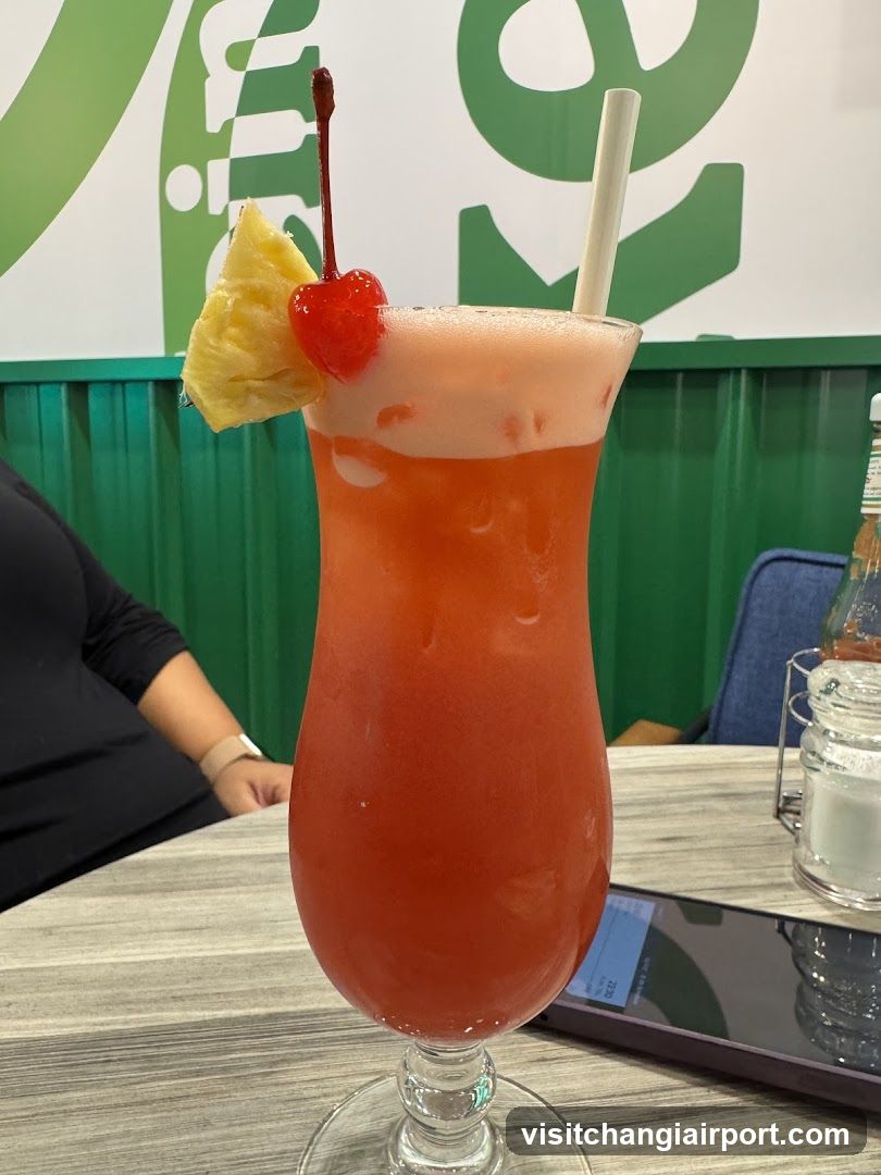 Pink Cocktail with Pineapple and Cherry Garnish