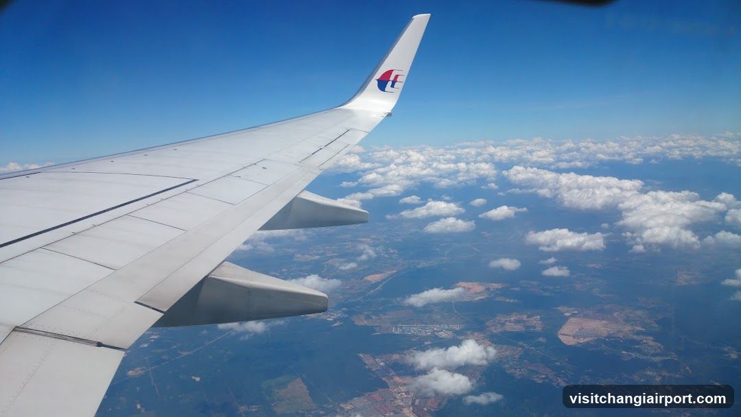 Aerial View of Airplane Wing and Clouds