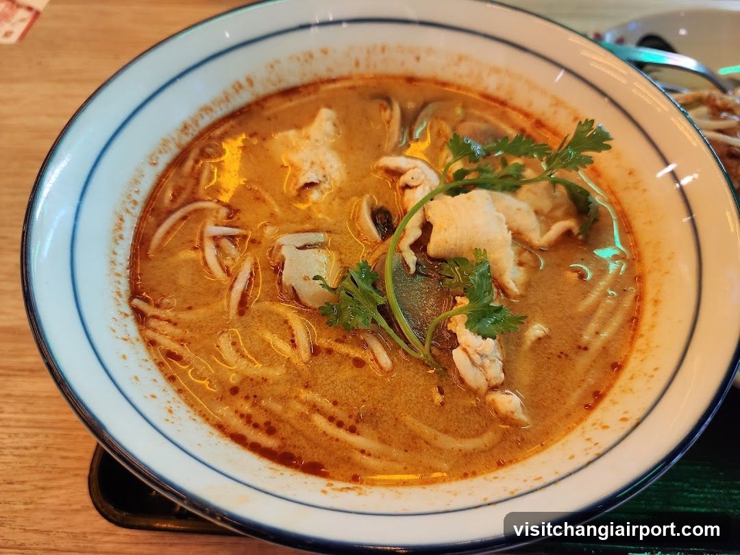 Bowl of Thai-style noodle soup with fish and herbs