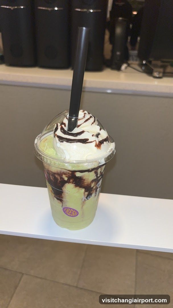 Iced Matcha Frappuccino with Whipped Cream and Chocolate Drizzle