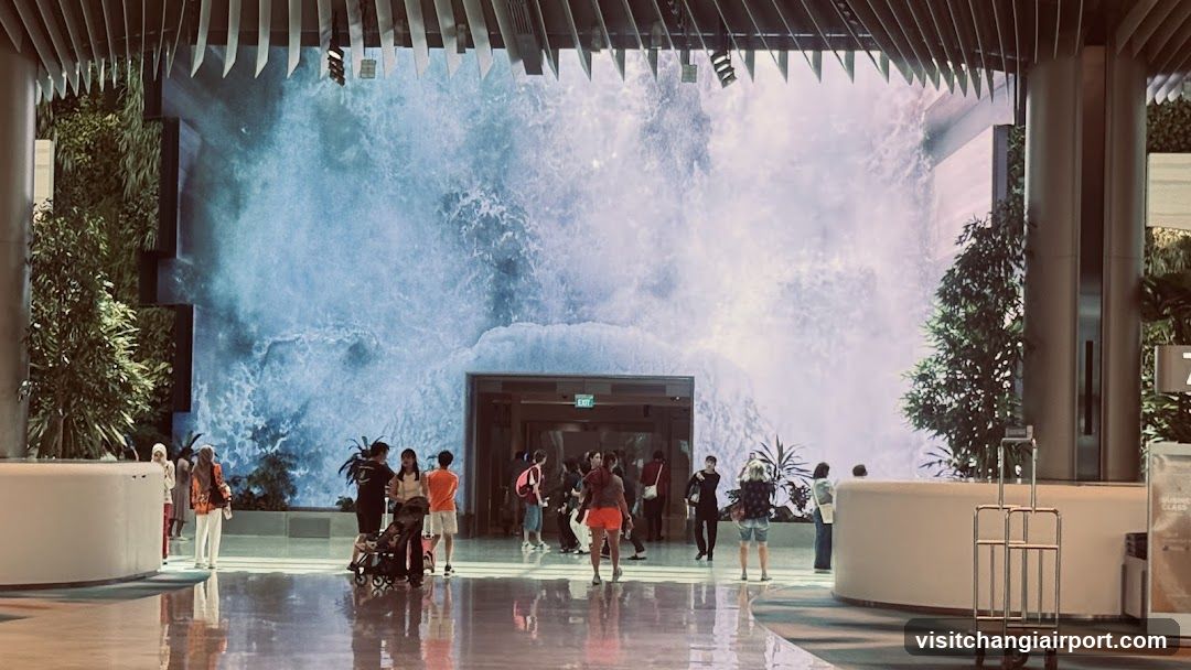 Indoor Waterfall Scene with Visitors