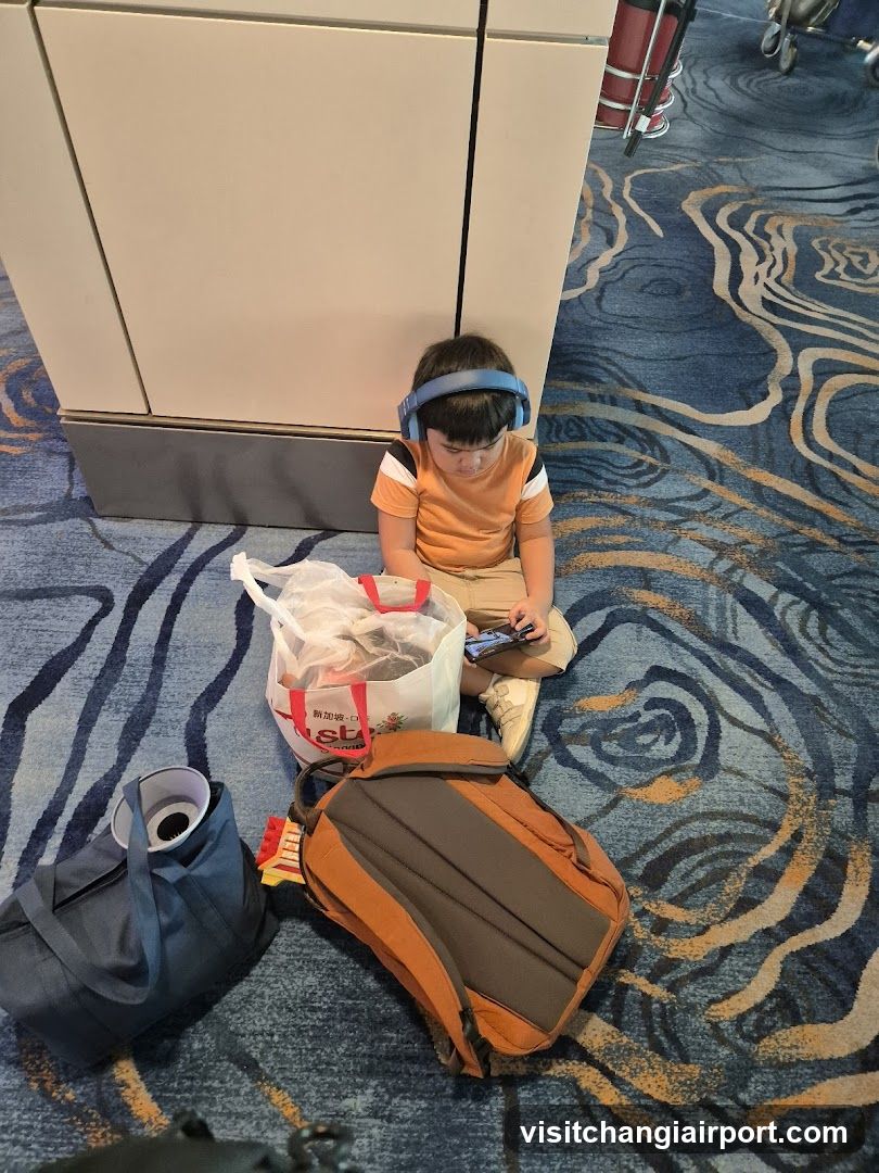 Child with headphones in airport terminal