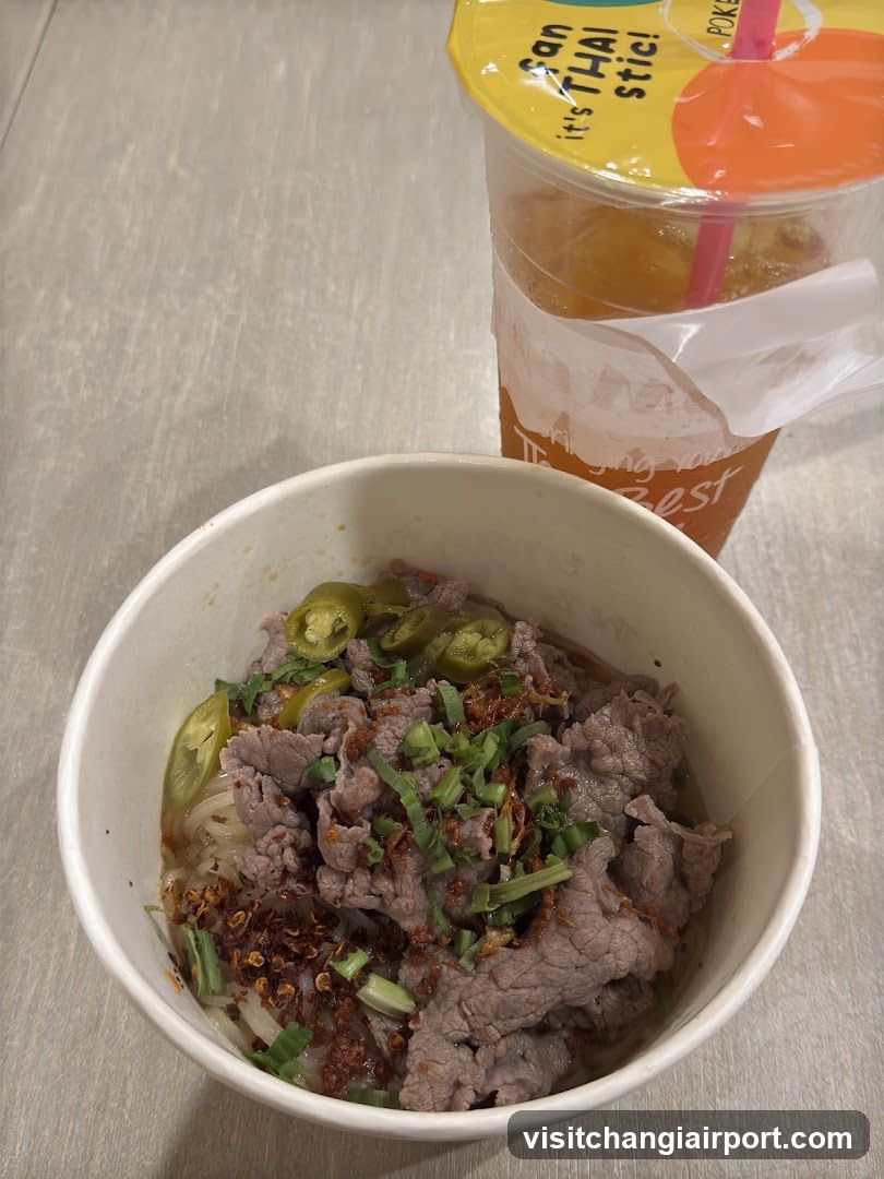 Bowl of noodles with beef and drink
