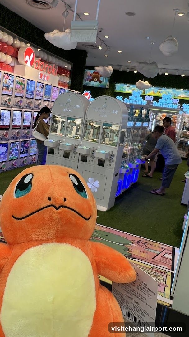 Pokémon-themed arcade interior with plush Charmander in foreground
