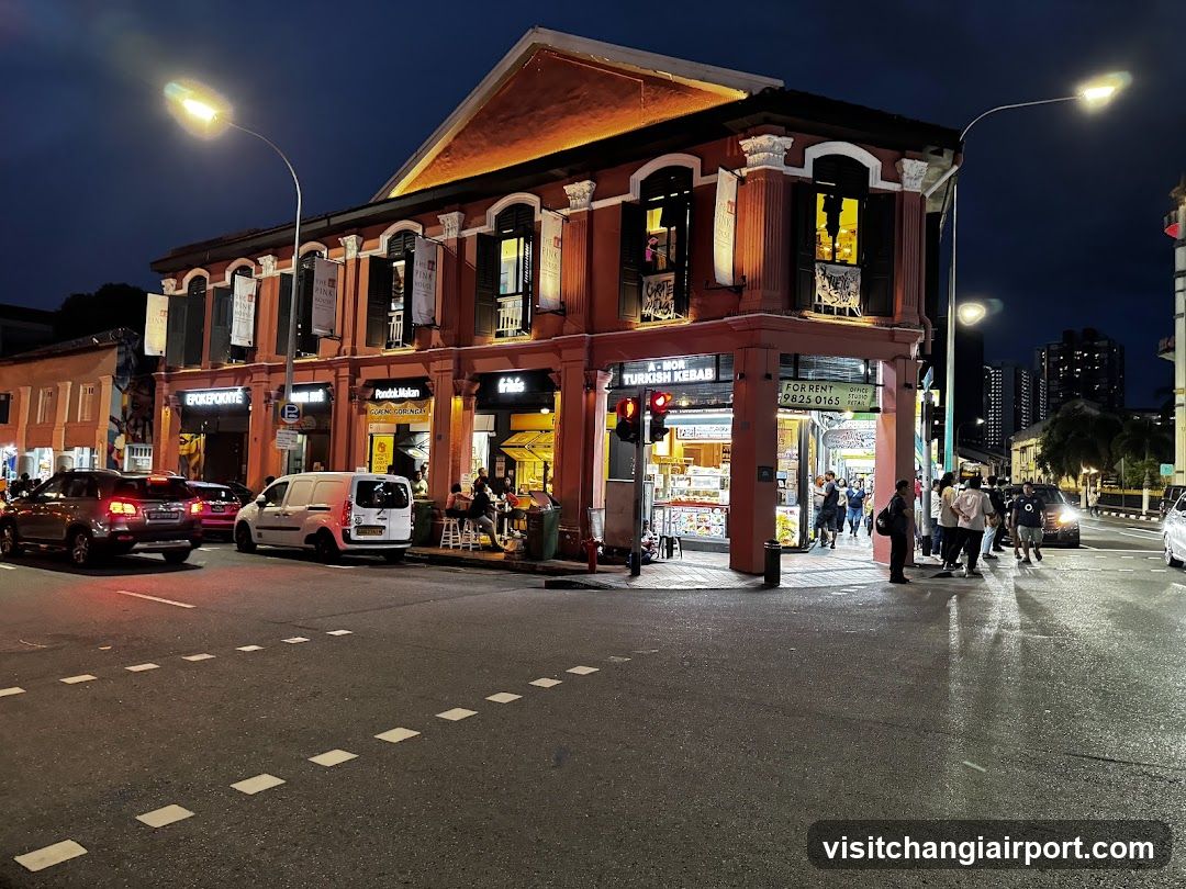 Night street scene with illuminated shop fronts