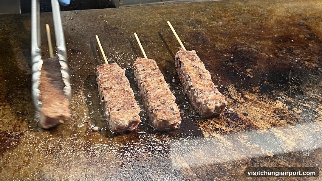 Grilled Meat Skewers on a Hot Plate