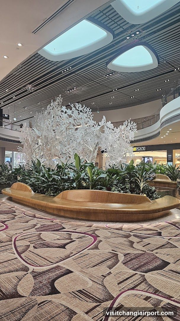 Shopping Mall Interior with Decorative Tree and Seating Area