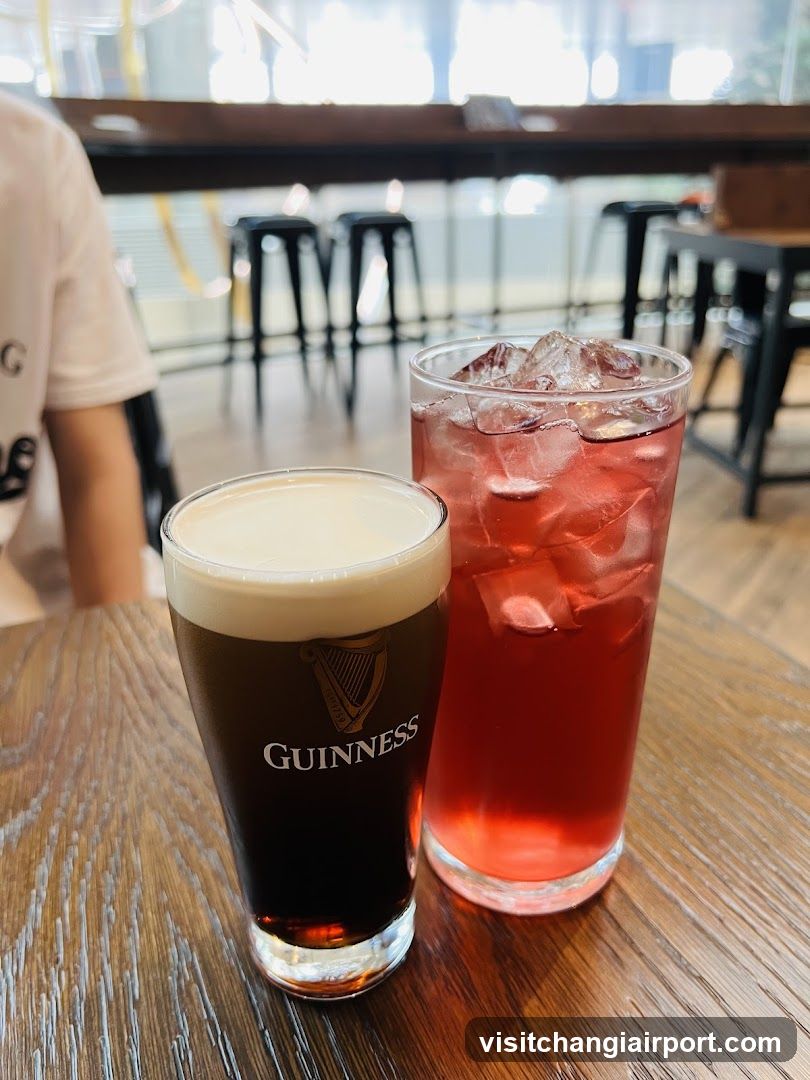 Guinness and Red Drink on Table