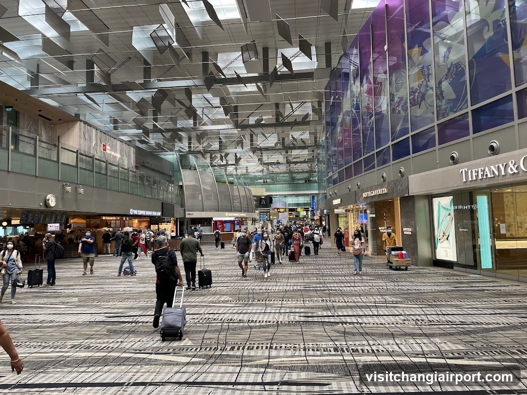 Airport Terminal Interior with Shops and Travelers