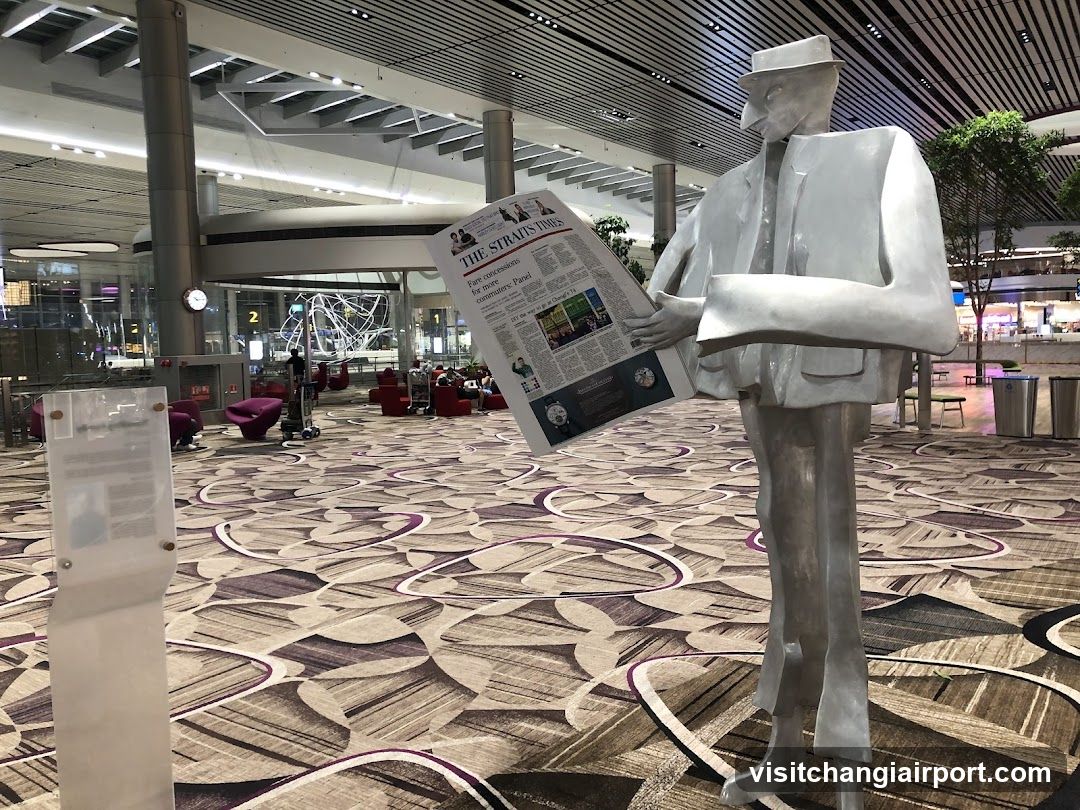 Statue Reading Newspaper in Airport Terminal