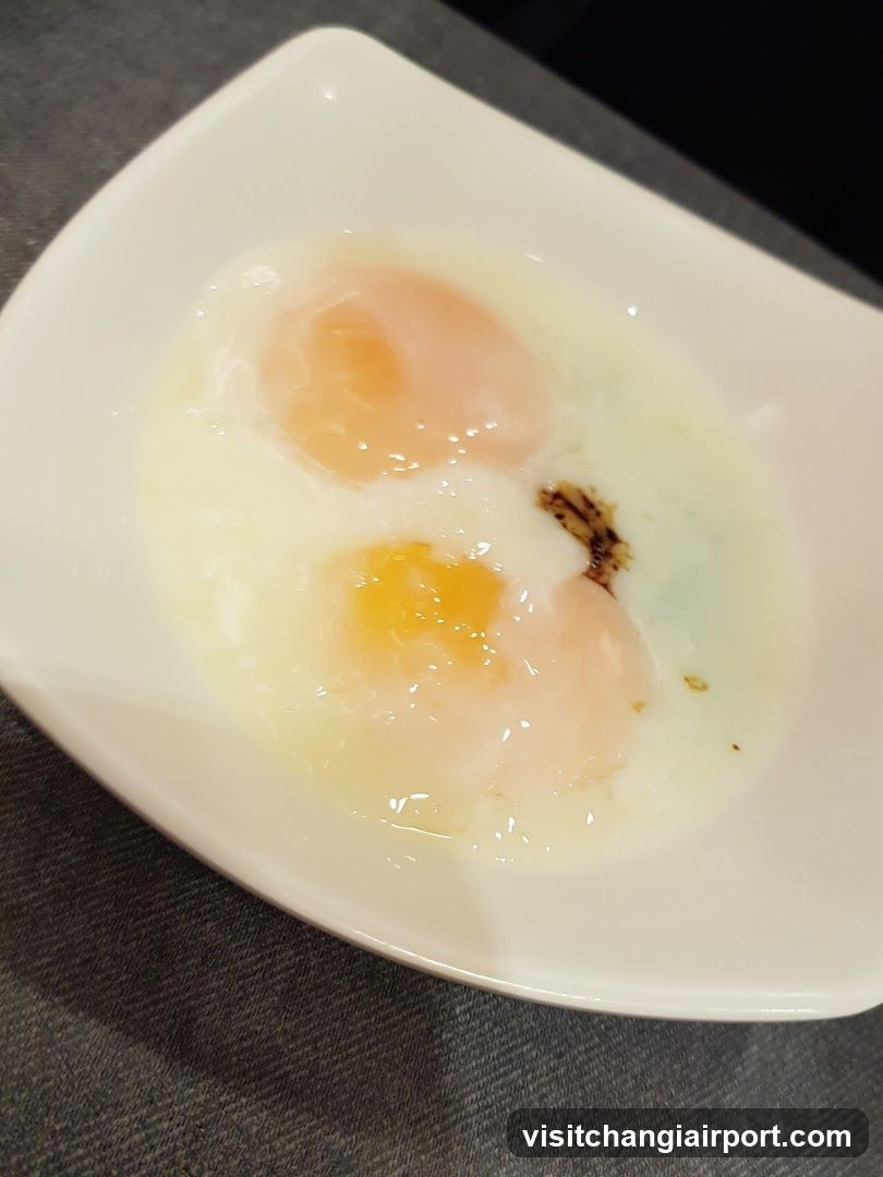 Two Poached Eggs in a White Bowl